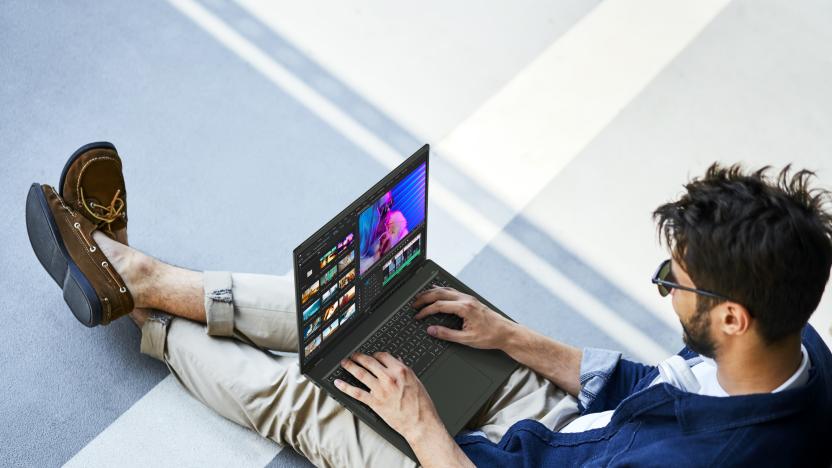 A chilled out man relaxes while using a laptop.