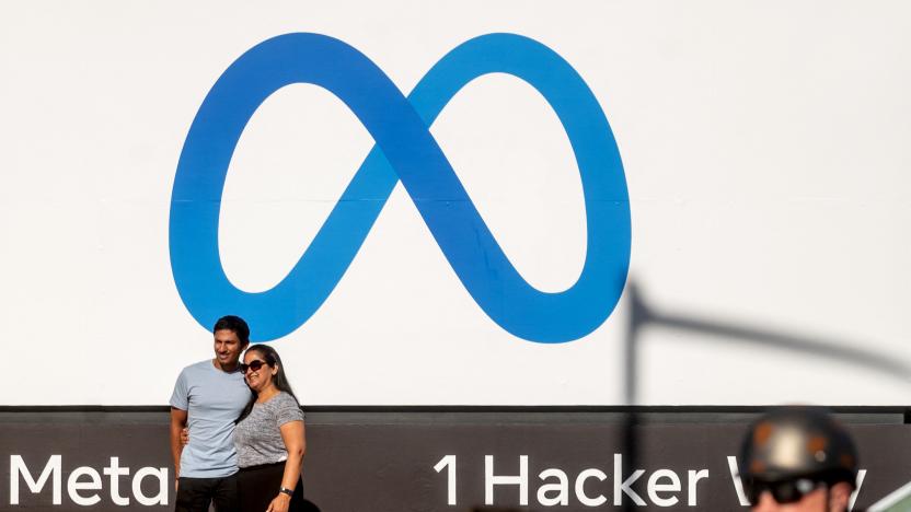 Visitors pose in front of a newly unveiled logo for "Meta", the new name for Facebook's parent company, outside Facebook headquarters in Menlo Park on October 28, 2021. - Facebook changed its parent company name to "Meta" on October 28 as the tech giant tries to move past being a scandal-plagued social network to its virtual reality vision for the future. (Photo by NOAH BERGER / AFP) (Photo by NOAH BERGER/AFP via Getty Images)