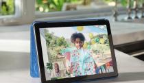 A tablet on a counter showing a photo of a little girl. 