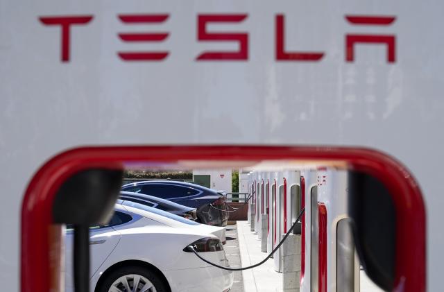 FILE - Tesla vehicles charge at a station in Emeryville, Calif., Aug. 10, 2022. In a document posted Tuesday, Aug. 1, 2023, U.S. auto safety regulators have opened another investigation into safety problems with Tesla vehicles concerning loss of steering control or loss of power steering in the 2023 Models 3 and Y electric vehicles. (AP Photo/Godofredo A. Vásquez, File)