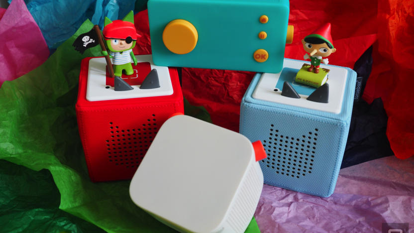 Two Tonieboxes, a Yoto Player and a Lunii on a bed of colored tissue paper