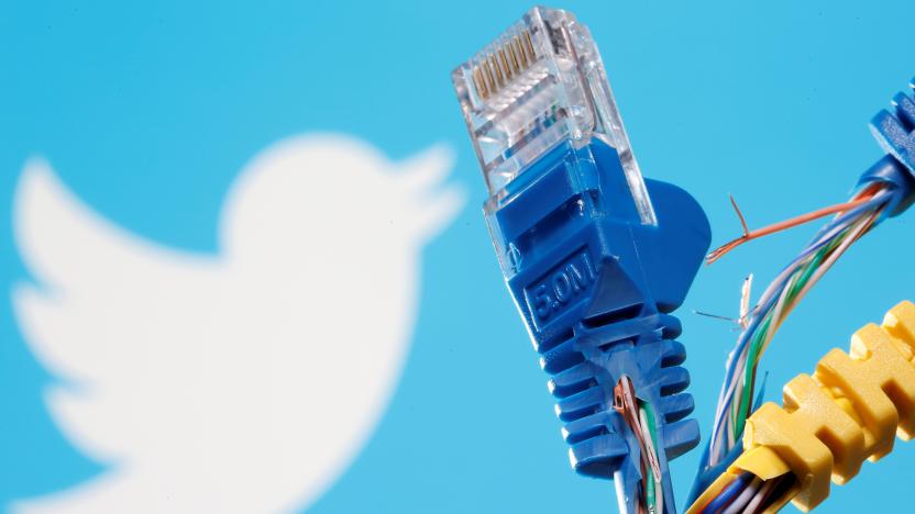 Broken Ethernet cables are seen in front of a displayed Twitter logo in this illustration taken October 5, 2021. REUTERS/Dado Ruvic/Illustration