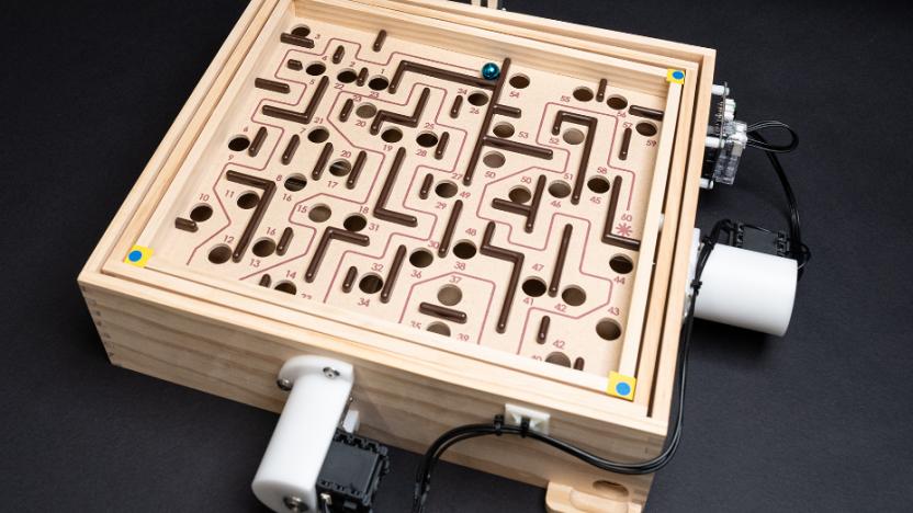 The marble game Labyrinth with motors atached to the dials.