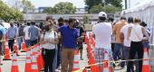 People wait in line to receive a COVID-19 vaccine at a FEMA vaccination center at Miami Dade College, Monday, April 5, 2021, in Miami. (AP Photo/Lynne Sladky)