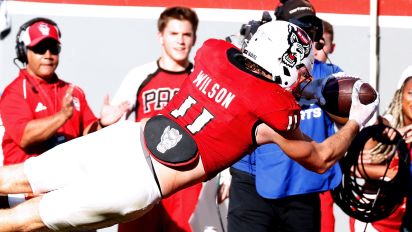 Getty Images - RALEIGH, NORTH CAROLINA - OCTOBER 28: Payton Wilson #11 of the NC State Wolfpack dives for a touchdown following his interception during the second half of the game against the Clemson Tigers at Carter-Finley Stadium on October 28, 2023 in Raleigh, North Carolina. NC State won 24-17. (Photo by Lance King/Getty Images)