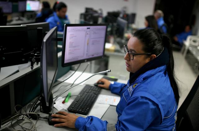 An employee of the city's health emergency number call center takes a call, amid the coronavirus disease (COVID-19) outbreak in Bogota, Colombia April 1, 2020. Picture taken April 1, 2020. REUTERS/Luisa Gonzalez