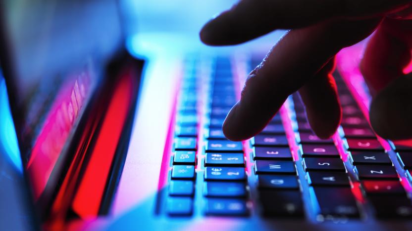 Man typing at his laptop computer at night