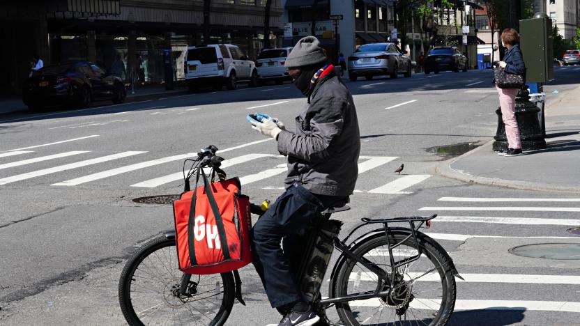 NEW YORK, NY - MAY 03: A Grubhub delivery person checks his phone during the coronavirus pandemic on May 3, 2020 in New York City. COVID-19 has spread to most countries around the world, claiming over 247,000 lives with over 3.5 million infections reported. (Photo by Cindy Ord/Getty Images)