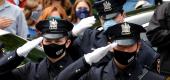 Glen Ridge Police Department officers wear protective face masks as they salute the funeral procession of their fellow officer Charles Roberts, after the 45-year-old father of three died of the coronavirus disease. (Reuters) 