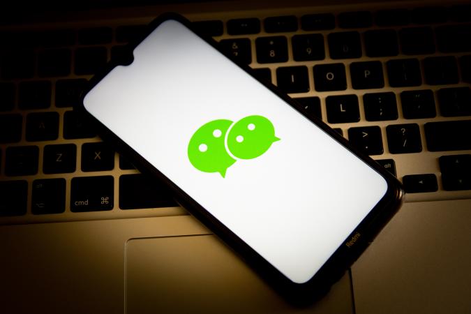 GREECE - 2021/04/23: In this photo illustration, a WeChat logo seen displayed on a smartphone screen with a computer keyboard in the background. (Photo Illustration by Nikolas Joao Kokovlis/SOPA Images/LightRocket via Getty Images)