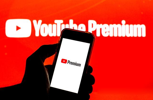 BARCELONA, CATALONIA, SPAIN - 2021/07/26: In this photo illustration a YouTube Premium logo seen displayed on a smartphone and in the background. (Photo Illustration by Thiago Prudêncio/SOPA Images/LightRocket via Getty Images)