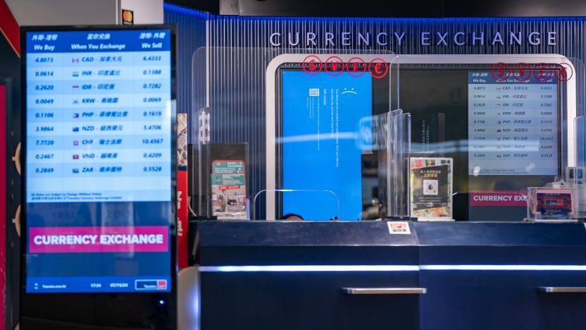 HONG KONG, CHINA - JULY 19: A error blue screen is displayed at a currency exchange store at the Hong Kong International Airport on July 19, 2024 in Hong Kong, China. A significant Microsoft outage impacted users globally, leading to widespread disruptions, including cancelled flights and disruptions at retailers globally. Airlines like American Airlines and Southwest Airlines reported difficulties with their systems, which rely on Microsoft services for operations. The outage affected check-in processes and other essential functions, causing frustration among travellers and lines to back up at many affected airports worldwide. (Photo by Anthony Kwan/Getty Images)