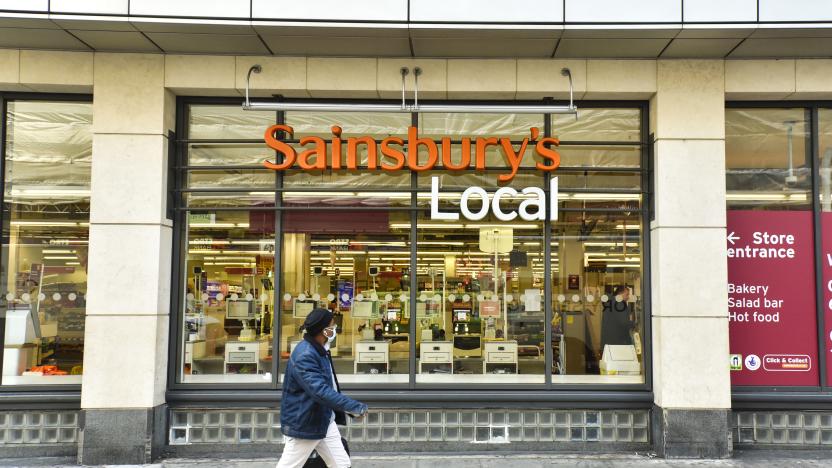 LONDON, UNITED KINGDOM - 2020/11/05: A man wearing a face mask walks past the Sainsburys shop in Holborn, London as Sainsbury's announce they are to cut 3,500 jobs and close 420 Argos stores. (Photo by Dave Rushen/SOPA Images/LightRocket via Getty Images)