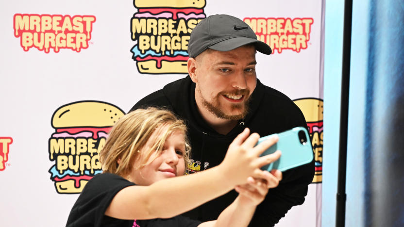 EAST RUTHERFORD, NEW JERSEY - SEPTEMBER 04: Global YouTube star MrBeast (R) poses with fan at the launch of the first physical MrBeast Burger Restaurant at American Dream on September 4, 2022 in East Rutherford, New Jersey. (Photo by Dave Kotinsky/Getty Images for MrBeast Burger)