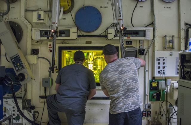 Brian Simmons, right, and Freddy Rodriguez process nuclear operators at the Idaho National Laboratory using master-slave manipulators to work with radioactive material inside a hot cell that hasn't been entered since 1974. Simmons was in the same accident with Ralph Stanton on Nov. 8, 2011, exposing him to alpha radiation-emitting americium and plutonium, which can be deadly when inhaled. (Chad Estes/McClatchy DC/Tribune News Service via Getty Images)