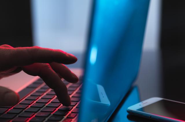 Man typing on a laptop.