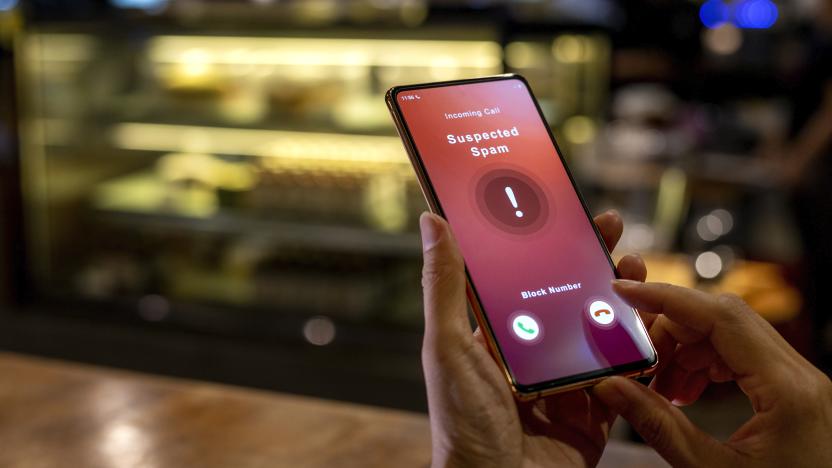 A woman receiving an incoming suspected spam call on her phone. The network provider detect the scam and show warning sign, woman rejects the call.