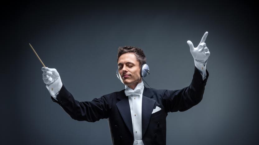 Conductor with headphones in studio