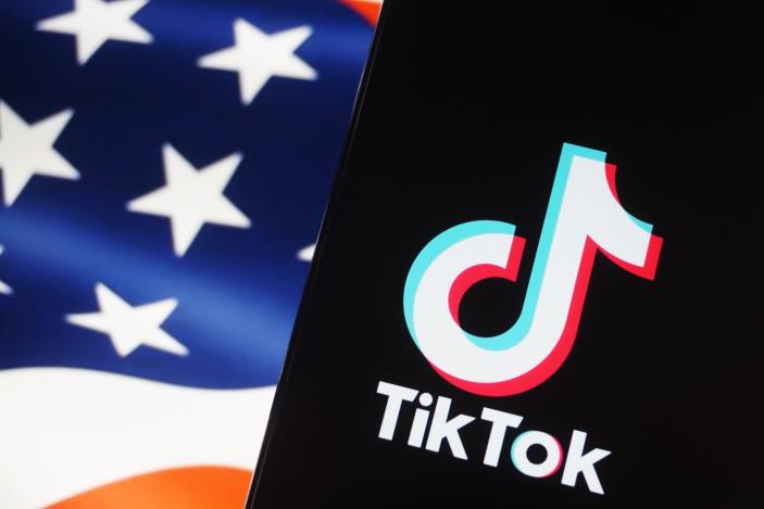 HANGZHOU, CHINA - MAY 08 2024: A setup image of a phone screen showing TikTok and a screen showing Stars and Stripes. (Photo credit should read LONG WEI / Feature China/Future Publishing via Getty Images)