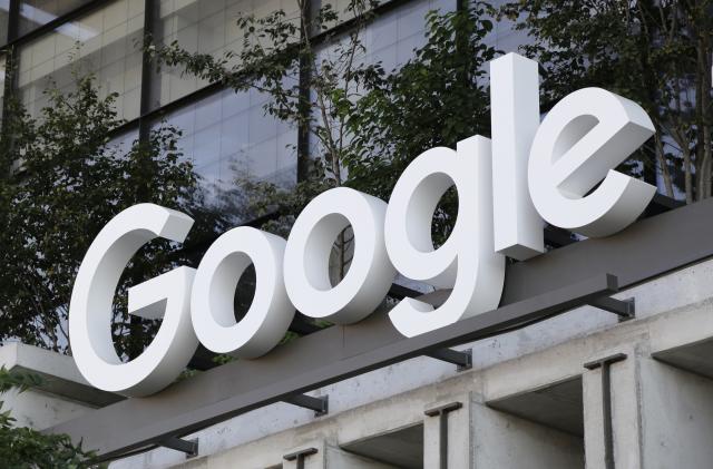 FILE - The Google sign is shown over an entrance to the company's new building in New York on Sept. 6, 2023. Google has agreed to pay $700 million and make several other concessions to settle allegations that it had been stifling competition against its Android app store — the same issue that went to trial in a another case that could result in even bigger changes. (AP Photo/Peter Morgan, File)