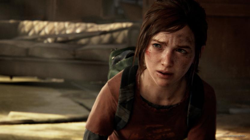 Gameplay still of Ellie from ‘The Last of Us Part I’ for PC, looking pensive in a shadowy environment.