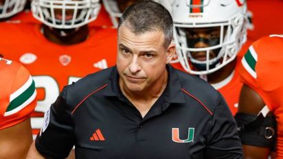 Getty Images - Miami Hurricanes coach Mario Cristobal and the team prepare to take the field before the game against Miami of Ohio Redhawks at hard Rock Stadium in Miami Gardens, Florida on Friday, Sept. 1, 2023. (Al Diaz/Miami Herald/Tribune News Service via Getty Images)