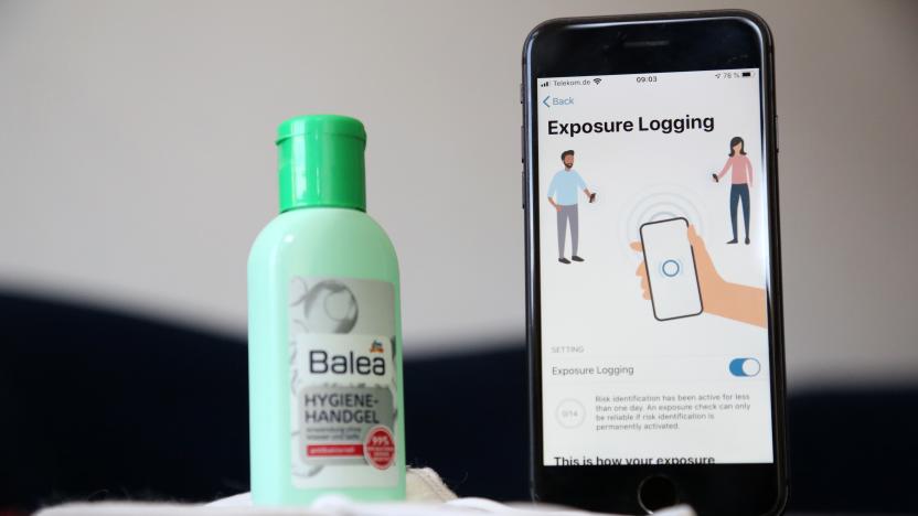 BERLIN, GERMANY - JUNE 16: The English version of the German federal health ministry's Corona-Warn-App software is seen on an Apple iPhone next to a medical facial mask and a bottle of hand sanitizer in this photo illustration on the day of the app's release during the novel coronavirus pandemic on June 16, 2020 in Berlin, Germany. Germany launched its contact tracing smartphone app, which uses short-range Bluetooth to alert people who may have been exposed to an individual who has contracted the coronavirus, without relying on a centralized database. The app was originally scheduled for launch in April, but was delayed due to technical difficulties and concerns over privacy issues. (Photo by Adam Berry/Getty Images)