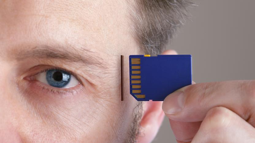 Inserting SD memory card into slot in human head concept for memory upgrage, forgetfulness or computing
