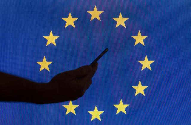 The EU flag is seen with logos of American technology companies. (Photo by Jaap Arriens/NurPhoto via Getty Images)