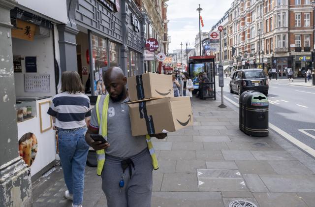 Delivery man with packages from Amazon Prime in Soho on 17th May 2022 in London, United Kingdom. Amazon Prime is a paid subscription service from Amazon which is available in various countries and gives users access to additional services otherwise unavailable or available at a premium to other Amazon customers. Services include same, one or two-day delivery of goods. (photo by Mike Kemp/In Pictures via Getty Images)