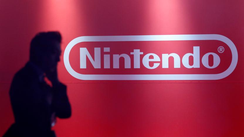 A man stands in front of Nintendo's logo at the presentation ceremony of its new game console Switch in Tokyo, Japan January 13, 2017. Picture taken January 13, 2017. REUTERS/Kim Kyung-Hoon