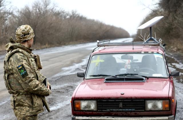 A Ukrainian serviceman stands next to a vehicle that carries a Starlink satellite internet system near the frontline, as Russia's attack on Ukraine continues, in Donetsk region, Ukraine February 27, 2023. REUTERS/Lisi Niesner