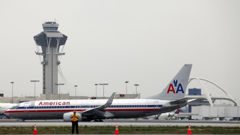 An American Airlines jet passes the Air Traffic Control Tower on the runway at Los Angeles International Airport (LAX), California April 24, 2013. Federal Aviation Administration (FAA) furloughs, which started Sunday, are intended to cut staffing by 10 percent to save $200 million of $637 million the agency needs to pare from its budget. Of 47,000 employees facing furloughs, which are expected to last through September, nearly 13,000 are air traffic controllers. REUTERS/Patrick T. Fallon (UNITED STATES - Tags: TRANSPORT BUSINESS EMPLOYMENT)