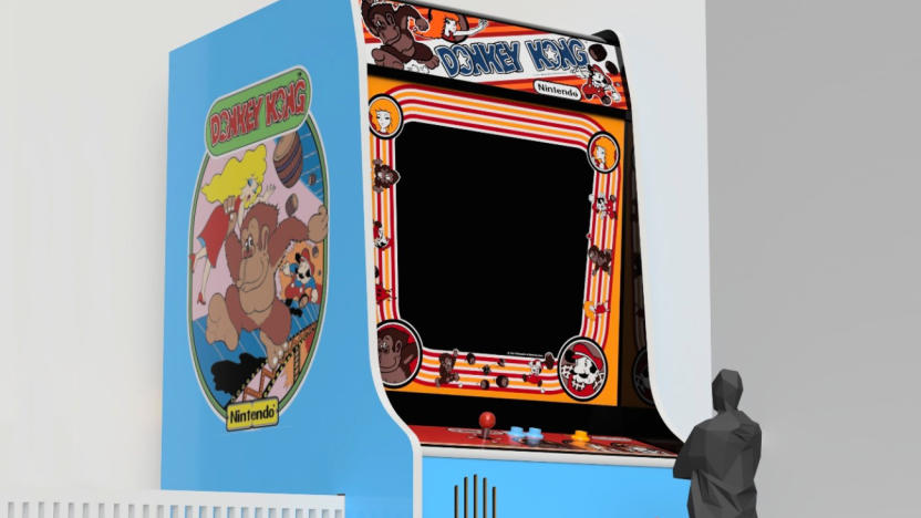 A large Donkey Kong arcade cabinet is shown with a black human figure standing at a smaller control panel in front of it.