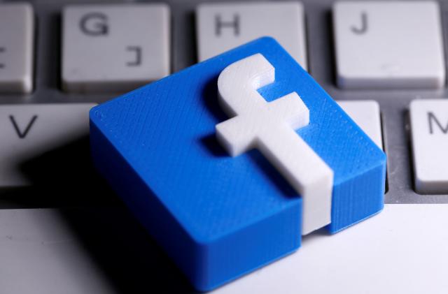 A 3D-printed Facebook logo is seen placed on a keyboard in this illustration taken March 25, 2020. REUTERS/Dado Ruvic/Illustration