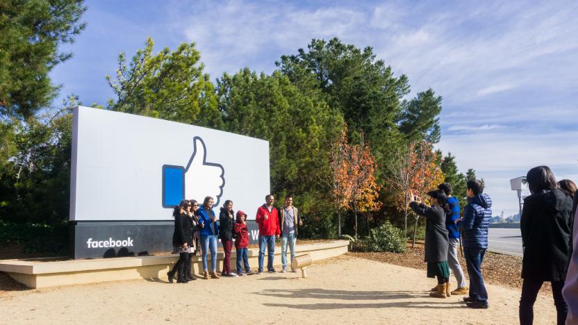 December 27, 2017 Menlo Park / CA / USA - A group of friends posing in front of the Facebook Like Button sign located at the entrance to the company's main headquarters located in Silicon Valley