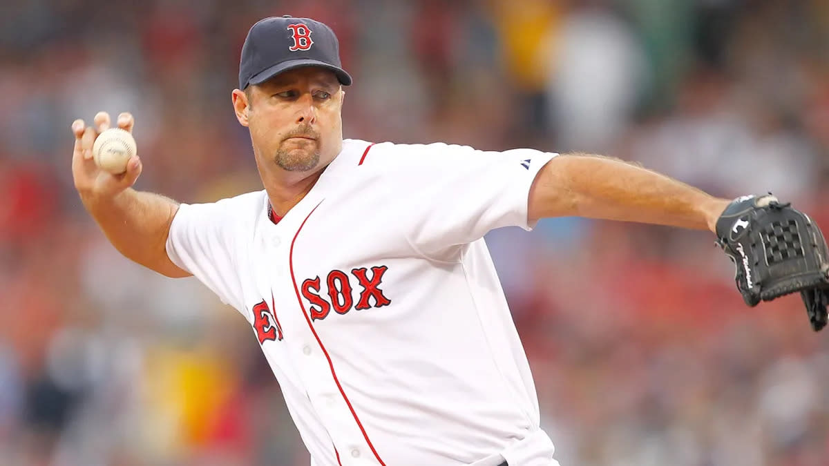 Boston Red Sox's Mike Lowell, right, is joined on the field by his