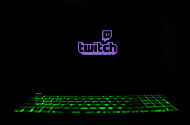 The Twitch logo is displayed on a laptop screen with a glowing keyboard in Krakow, Poland, on March 3, 2024. (Photo by Klaudia Radecka/NurPhoto via Getty Images)