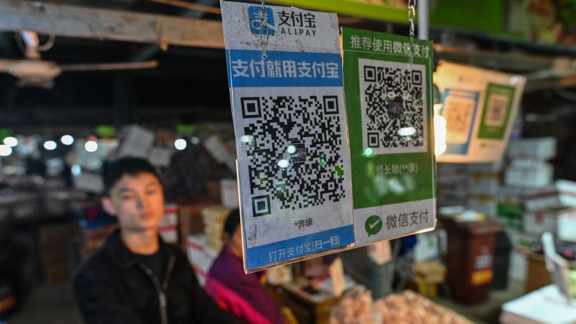 Alipay (L) and Wechat (R) QR payment codes are displayed at a market in Shanghai on October 27, 2020. (Photo by Hector RETAMAL / AFP) (Photo by HECTOR RETAMAL/AFP via Getty Images)