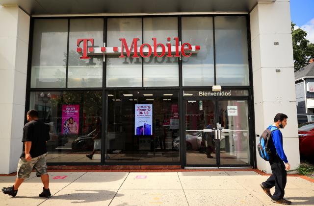 ARLINGTON, VA - AUGUST 18:  People walk past the front of a T-Mobile retail store on August 18, 2021 in Arlington, Virginia. T-Mobile announced Wednesday that a data breach exposed the personal information of 7.8 million current customers and 40 million people who had applied for credit. (Photo by Chip Somodevilla/Getty Images)