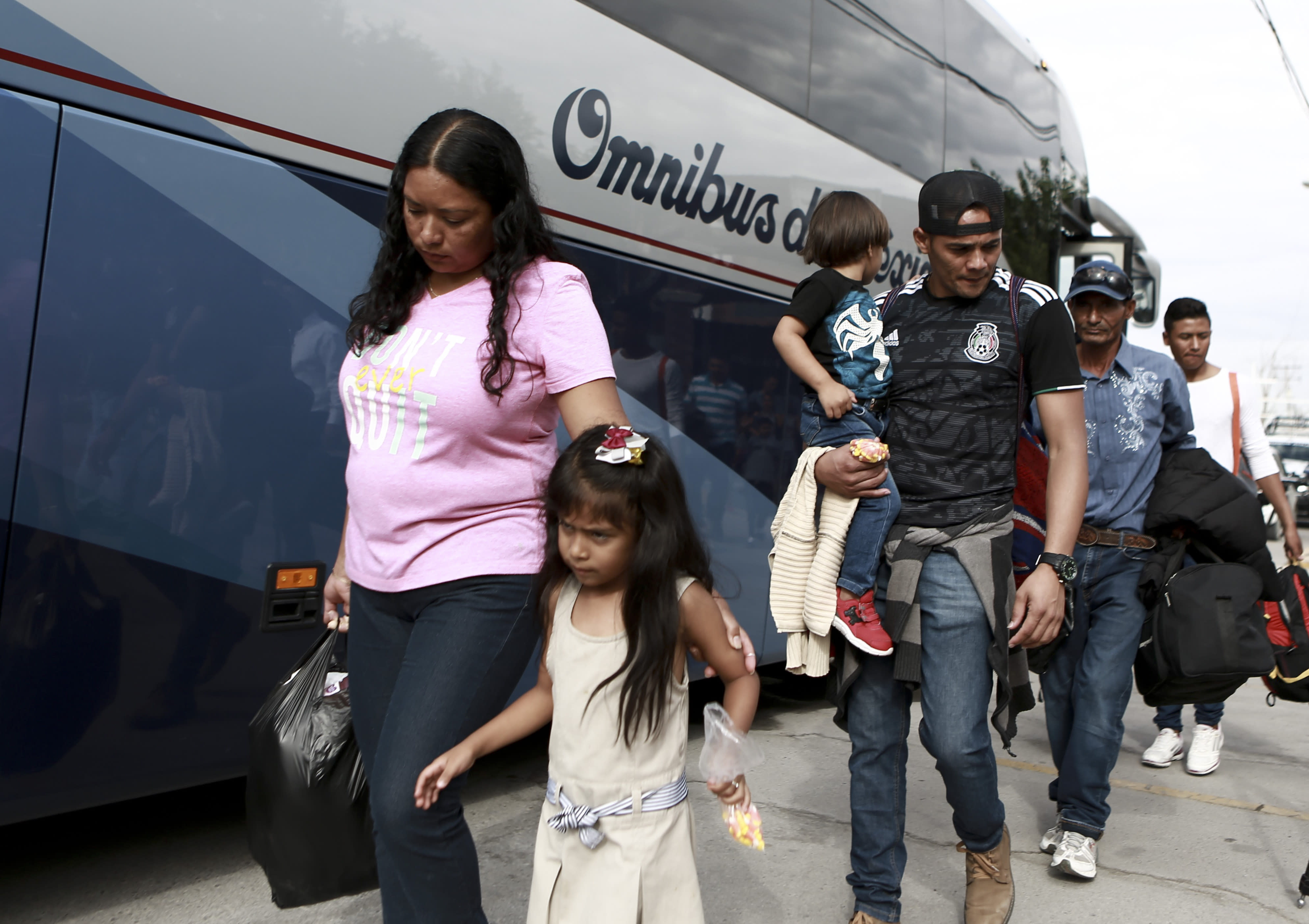 Central American migrants prepare to board a bus as they voluntarily return to their countries, in Ciudad Juarez, Mexico, Tuesday, July 2, 2019. Dozens of Central Americans who had been returned to the border city of Juarez to await the outcome of their U.S. asylum claims are being bused back to their countries Tuesday by Mexican authorities, a first for that size group of people in the program commonly known as âremain in Mexico.â (AP Photo/Christian Chavez)