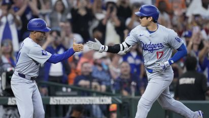 Associated Press - Los Angeles Dodgers designated hitter Shohei Ohtani, right, is congratulated by third base coach Dino Ebel, left, after hitting a solo home run during the third inning of a baseball game against the Houston Astros, Saturday, July 27, 2024, in Houston. (AP Photo/Kevin M. Cox)