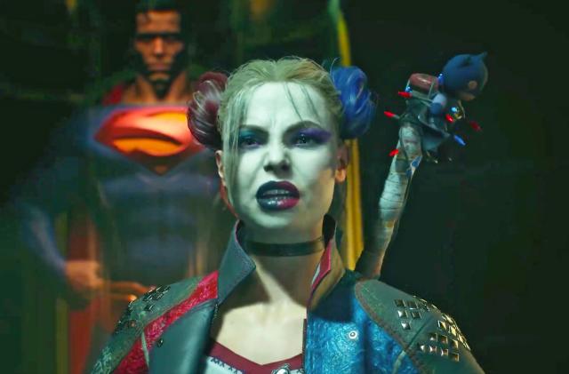 A shot from the game Suicide Squad: Kill the Justice League showing Harley Quinn with a bat peeking out from over her shoulder and Superman a few feet behind here.