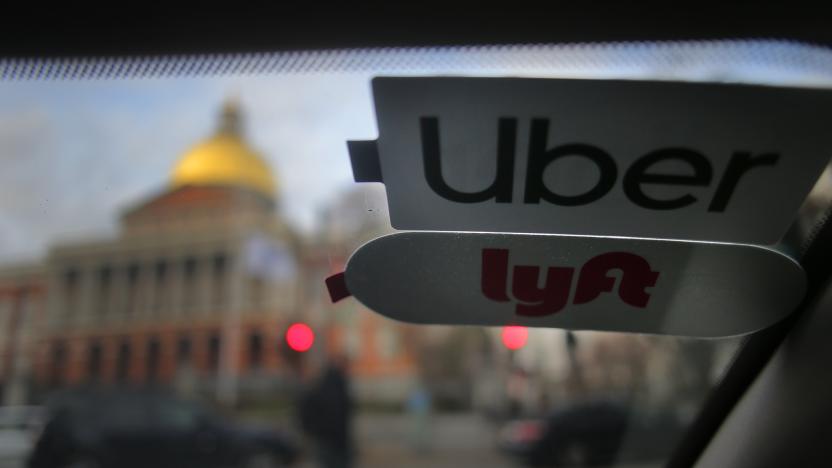 BOSTON, MA - NOVEMBER 14: Uber and Lyft stickers are pictured inside a ride share vehicle outside the Massachusetts State House in Boston on Nov. 14, 2019. Many drivers pick up fares for both companies. That boxy delivery truck blocking your lane is just one maddening manifestation of a public failure to adapt to the new convenience economy. The technology built around our desire for instant gratification - Uber and Lyft, DoorDash and Grubhub, the Amazon packages whizzing from distribution centers to our doorsteps - has become the source of huge amounts of new traffic. Hundreds of thousands of these trips would never have happened just a few years ago. But the public policy response has been no match for this challenge, the Globe Spotlight Team has found. In Boston, in fact, the operative policy only enables the offender. It is part of a pattern of delayed or passive public response to our slow-moving crisis in commuting. True, state officials were a nose ahead of the pack in imposing a surcharge on Uber and Lyft rides three years ago - an attempt at the time to make the companies pay their share of transportation costs - but now they have fallen out of the vanguard. Confronted by the powerful ride-share lobby on Beacon Hill, state leaders havent summoned the will or nerve to impose the kind of high fees and stringent limits other cities are using to try to curb the traffic. (Photo by Lane Turner/The Boston Globe via Getty Images)