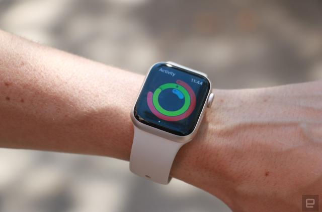 The Apple Watch SE (2022) on a person's wrist, showing the Activity app and rings.