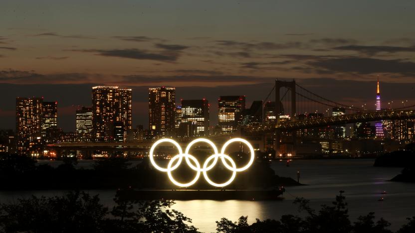 A general view of the Olympic Rings installed on a floating platform with the Rainbow Bridge in the background in preparation for the Tokyo 2020 Olympic Games in Tokyo, Japan June 21, 2021. Picture taken with long exposure.  REUTERS/Pawel Kopczynski