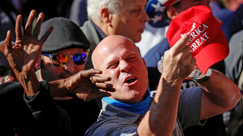 MAGA fans showing off their red hat.