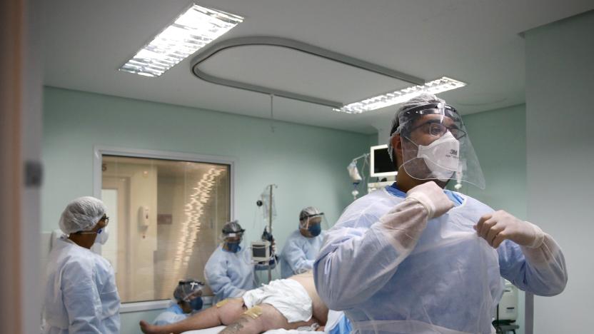 A medical worker is seen near a patient at the intensive care unit (ICU) of the Nossa Senhora da Conceicao hospital, during the coronavirus disease (COVID-19) outbreak, in Porto Alegre, Brazil, November 19, 2020. Picture taken November 19, 2020. REUTERS/Diego Vara