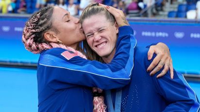 Getty Images - PARIS, FRANCE - AUGUST 10:  Alyssa Naeher of United States (R) and Trinity Rodman of United States (L) celebrate with their gold medal after winningthe Women's Gold Medal match between Brazil and United States of America during the Olympic Games Paris 2024 at Parc des Princes on August 10, 2024 in Paris, France. (Photo by Daniela Porcelli/ISI Photos/Getty Images)