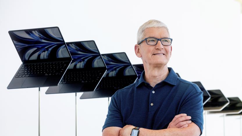 FILE - Apple CEO Tim Cook stands in front of a display of new Apple MacBook Air computers with M2 processors, Monday, June 6, 2022, following the keynote presentation of Apple's World Wide Developer Conference on the campus of Apple's headquarters in Cupertino, Calif. Apple's foray into live sports took a big step forward Tuesday, June 14, 2022. Apple and Major League Soccer have announced a 10-year partnership on a streaming service that will allow fans to watch every game without local blackouts or restrictions. The service will be available exclusively through the Apple TV app beginning next year. (AP Photo/Noah Berger, File)